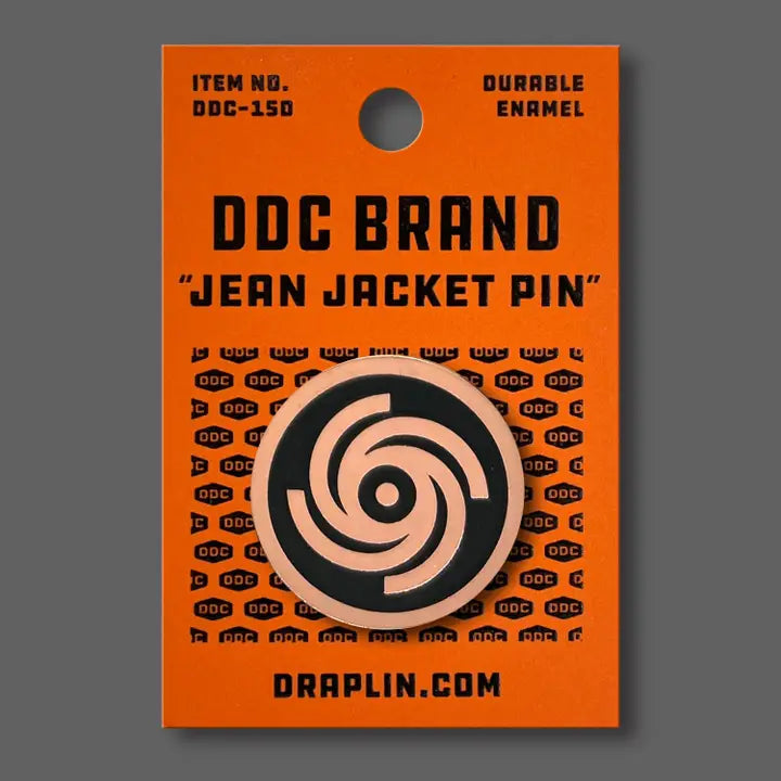 Draplin Design Company Gyrating Galaxy copper enamel pin with circular pattern on orange backing card