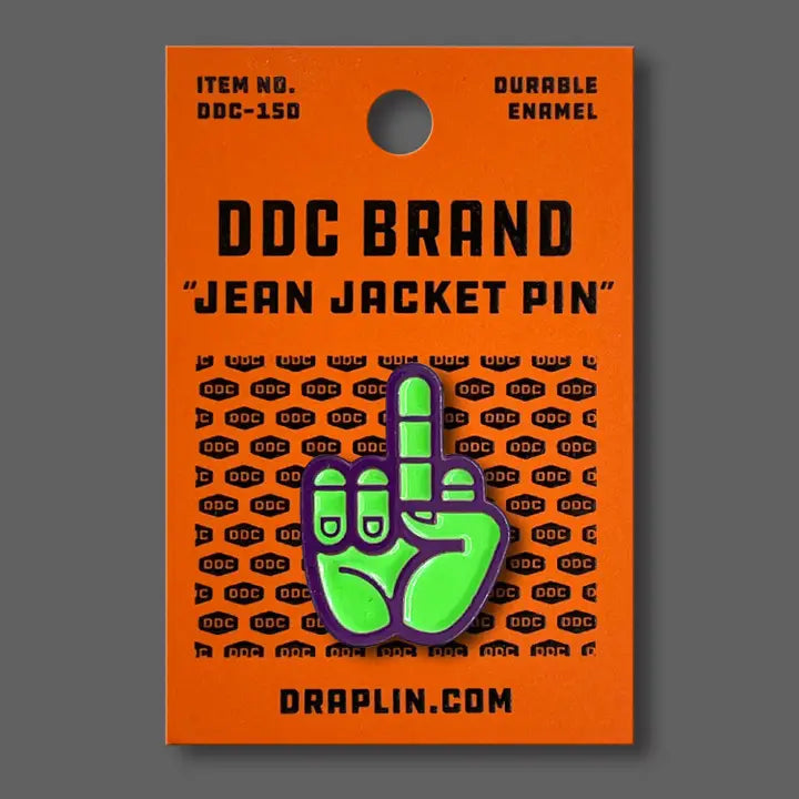 Draplin Design Company green and purple middle finger enamel pin on orange backing card