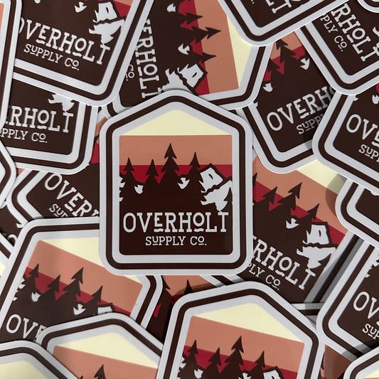 A collection of brown stickers with a red and brown tree logo and the text 'overholt supply co.'