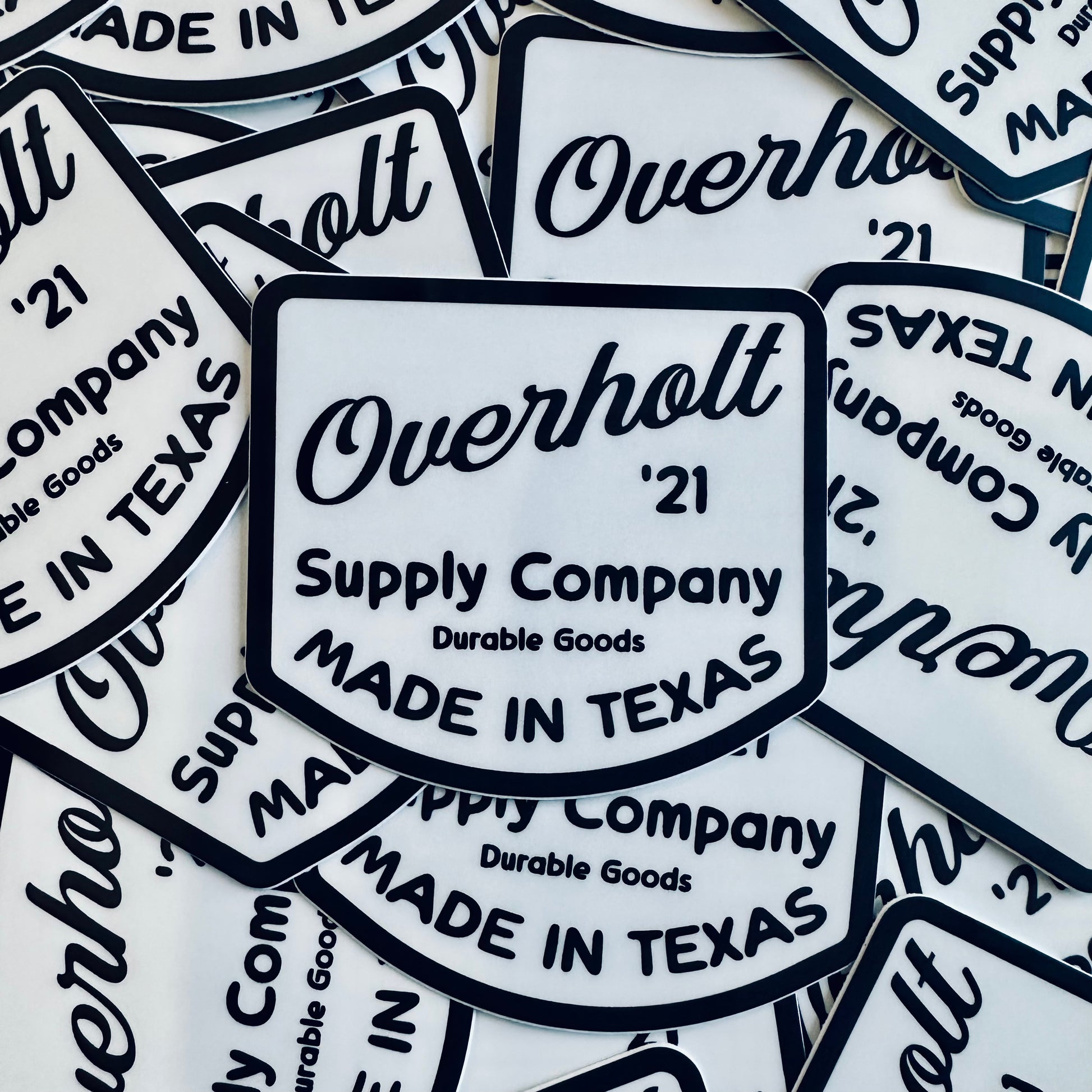 A collection of white decals with the text 'Overholt Supply Co' and vintage design elements, indicating that they are stickers with a retro aesthetic.