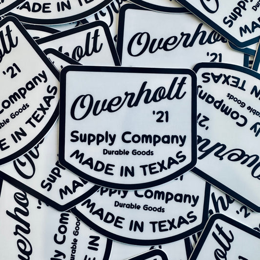 A collection of white decals with the text 'Overholt Supply Co' and vintage design elements, indicating that they are stickers with a retro aesthetic.