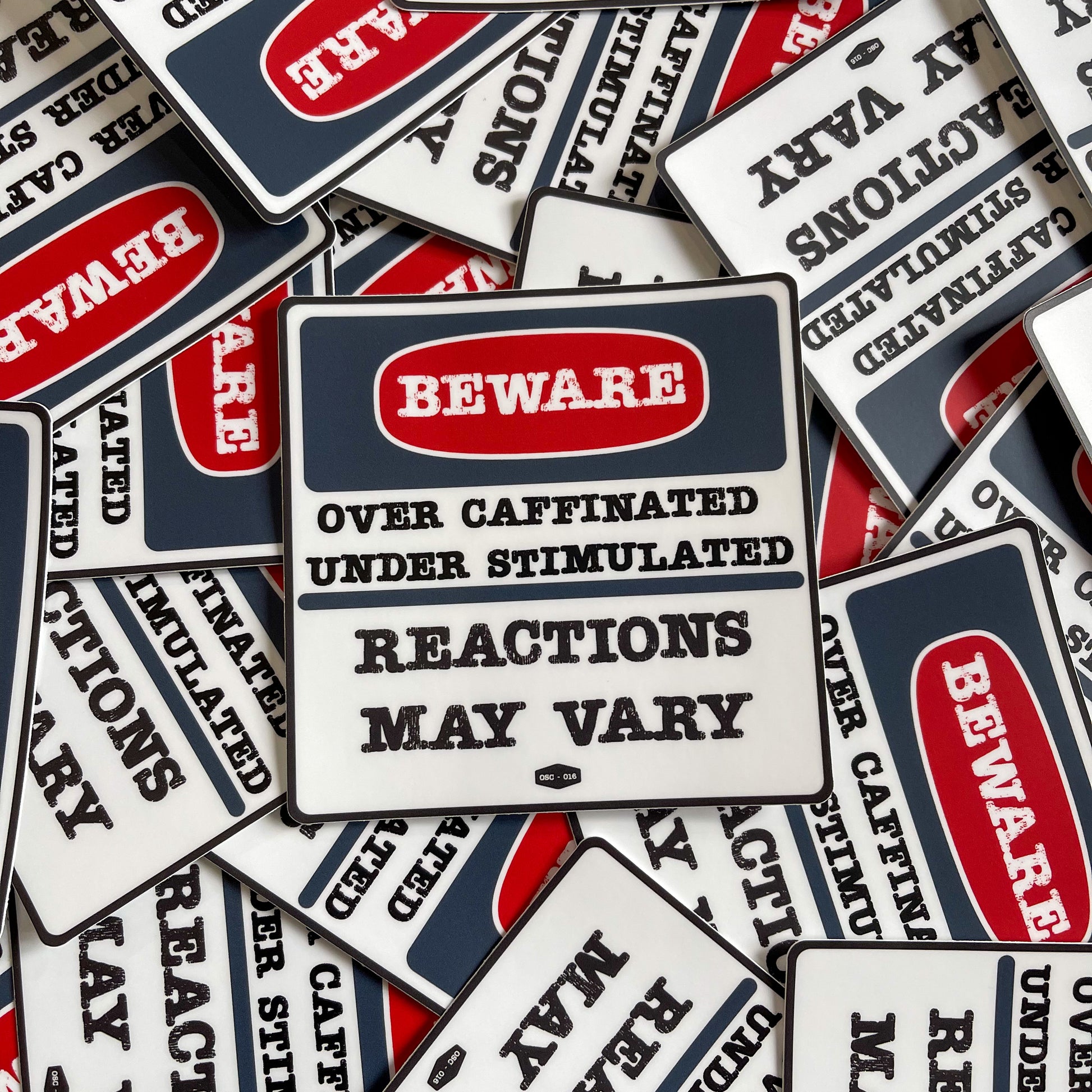 A collection of 'Beware Over Caffinated Under Stimulated Reactions May Vary' stickers from Overholt Supply Co.