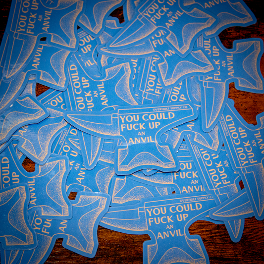 This image features a collection of blue stickers shaped like anvil tools, with a bold, white text that reads "You could fuck an anvil." These stickers are designed in a stylized, three-dimensional shape that mimics the intricate and durable design of an anvil.