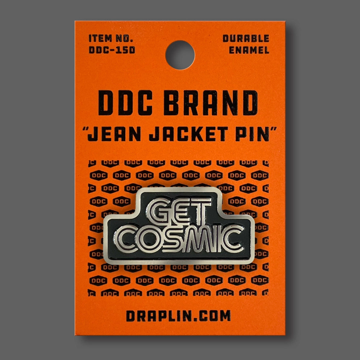 Draplin Design Company Get Cosmic enamel pin with bold typography on orange backing card