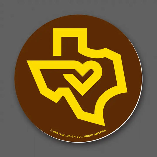 Draplin Design Company Texas Love decal with yellow Texas outline and heart on brown background