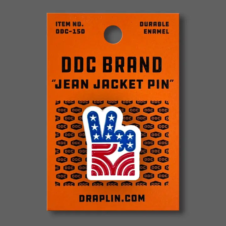 Draplin Design Company Peace Fingers Stars and Bars enamel pin on orange backing card