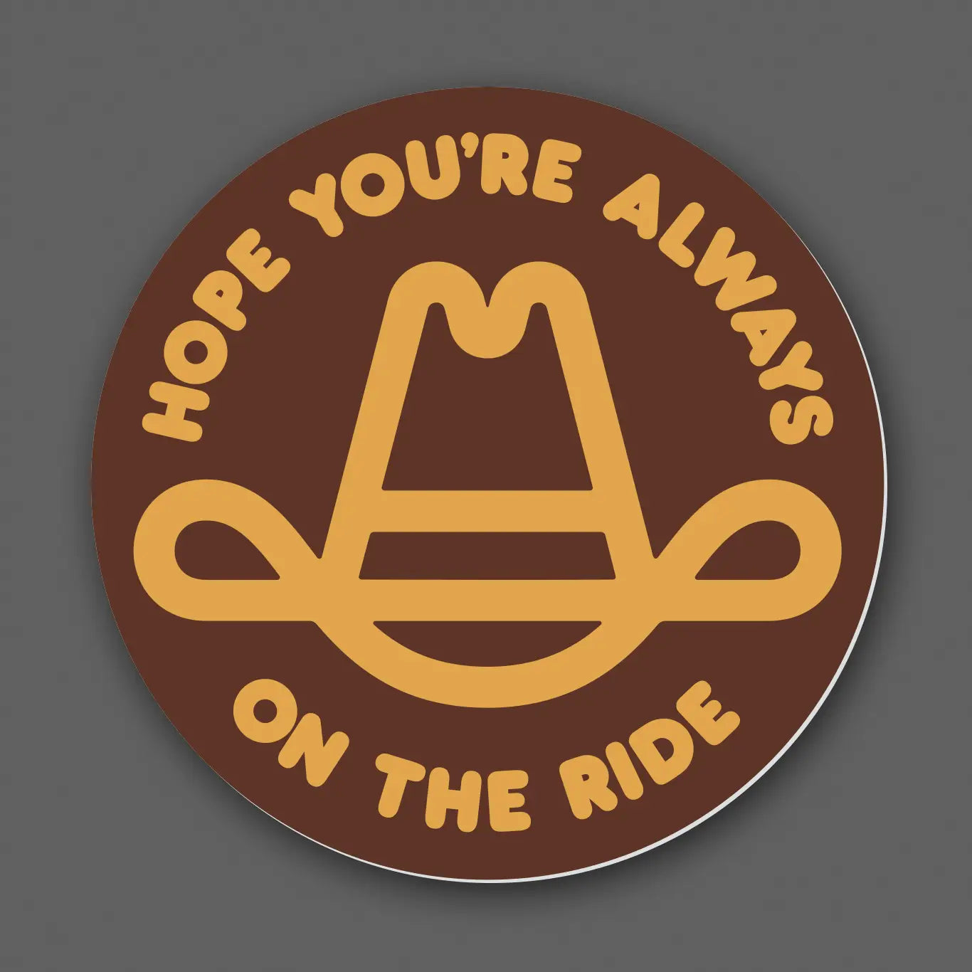 Draplin Design Company circular decal reading Hope You’re Always On The Ride in brown and gold