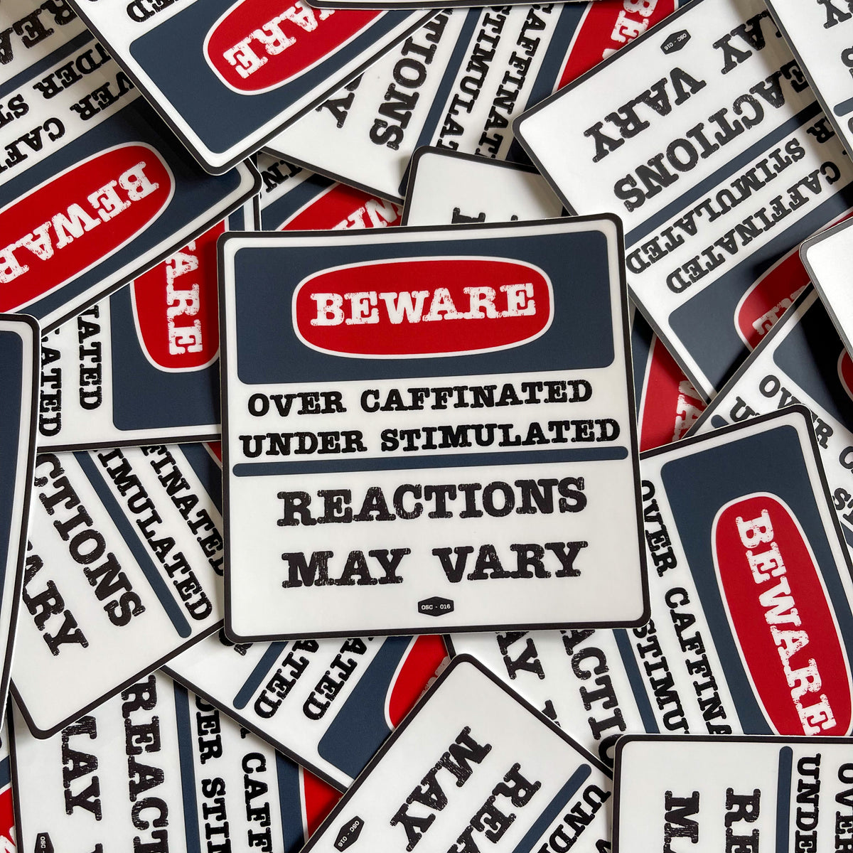 A collection of 'Beware Over Caffinated Under Stimulated Reactions May Vary' stickers from Overholt Supply Co.